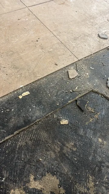 Black bitumen mastic floor removal in a WC2 flat